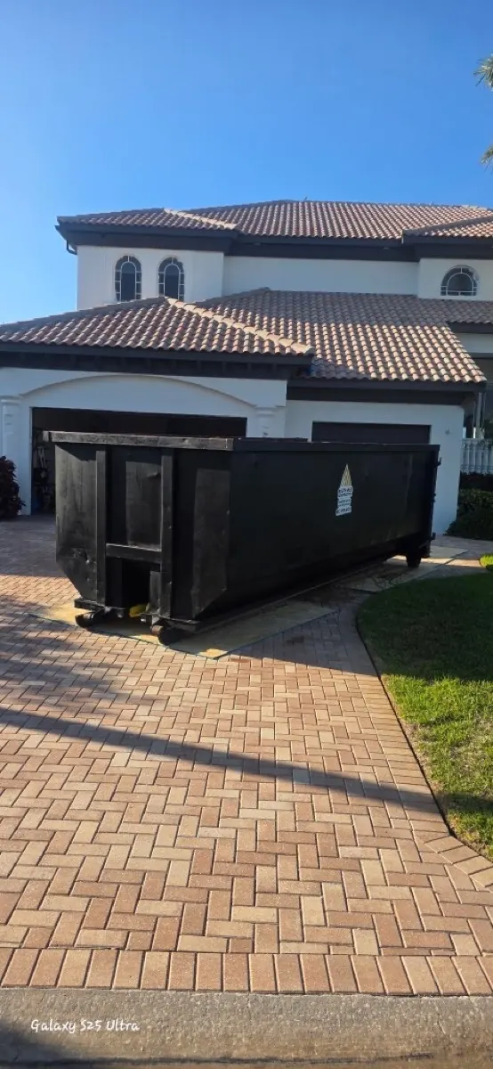 Roll-off dumpster on a paver driveway in Tampa